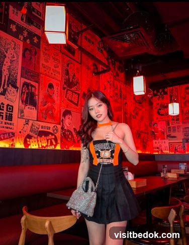 Woman Posing in a Restaurant with Vintage Posters