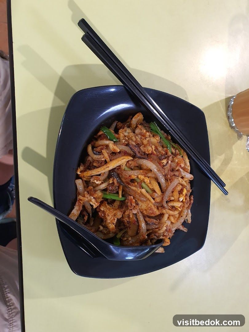 Stir-fried noodles with chopsticks and spoon