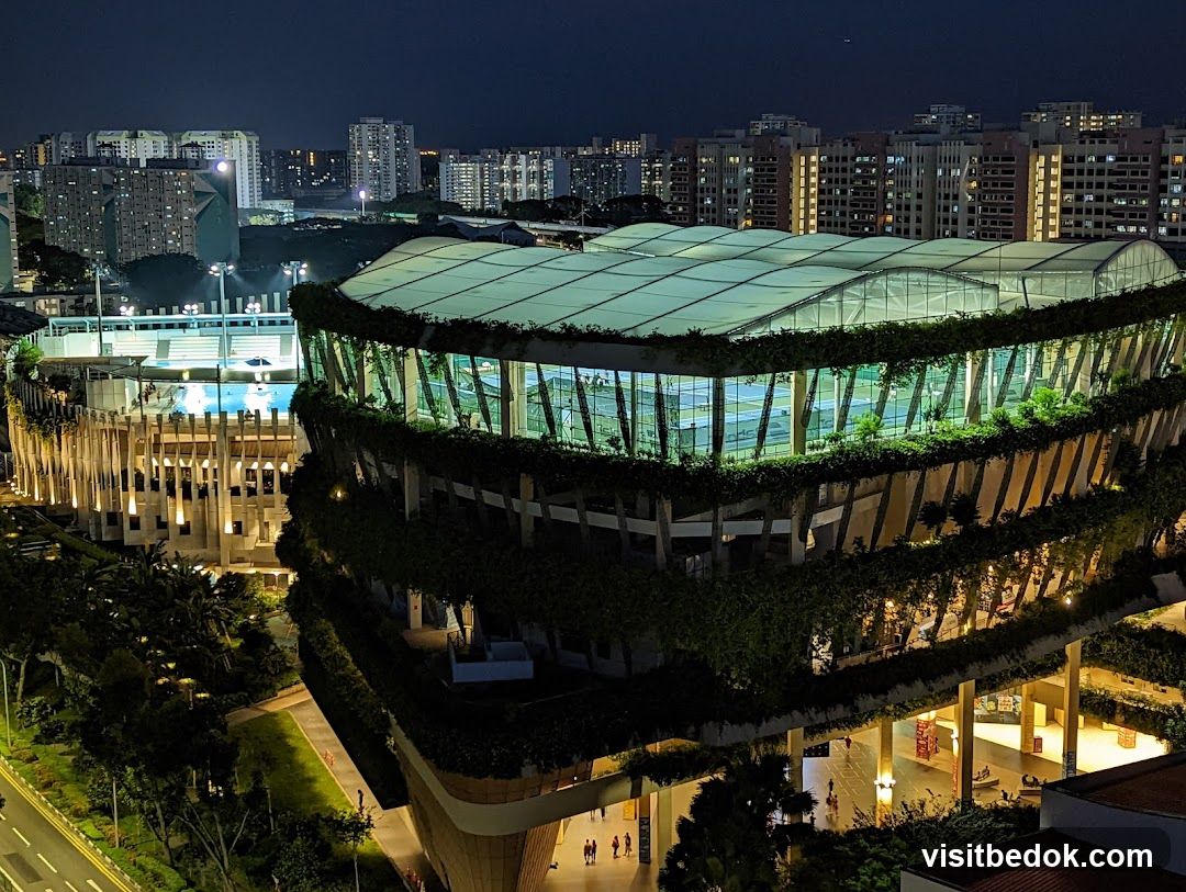 Modern Building with Greenery and Pool at Night