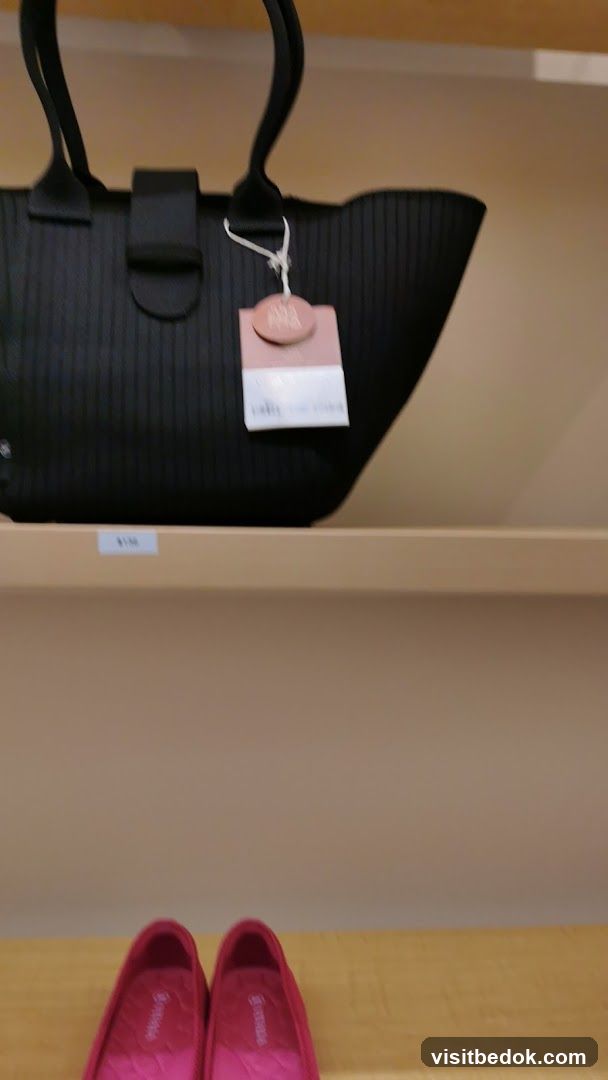 Black handbag and pink shoes on shelves