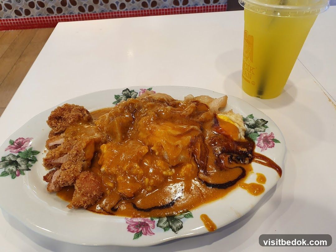Curry dish with fried chicken and drink