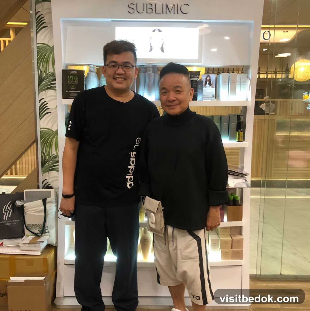 Two men posing in front of a display shelf