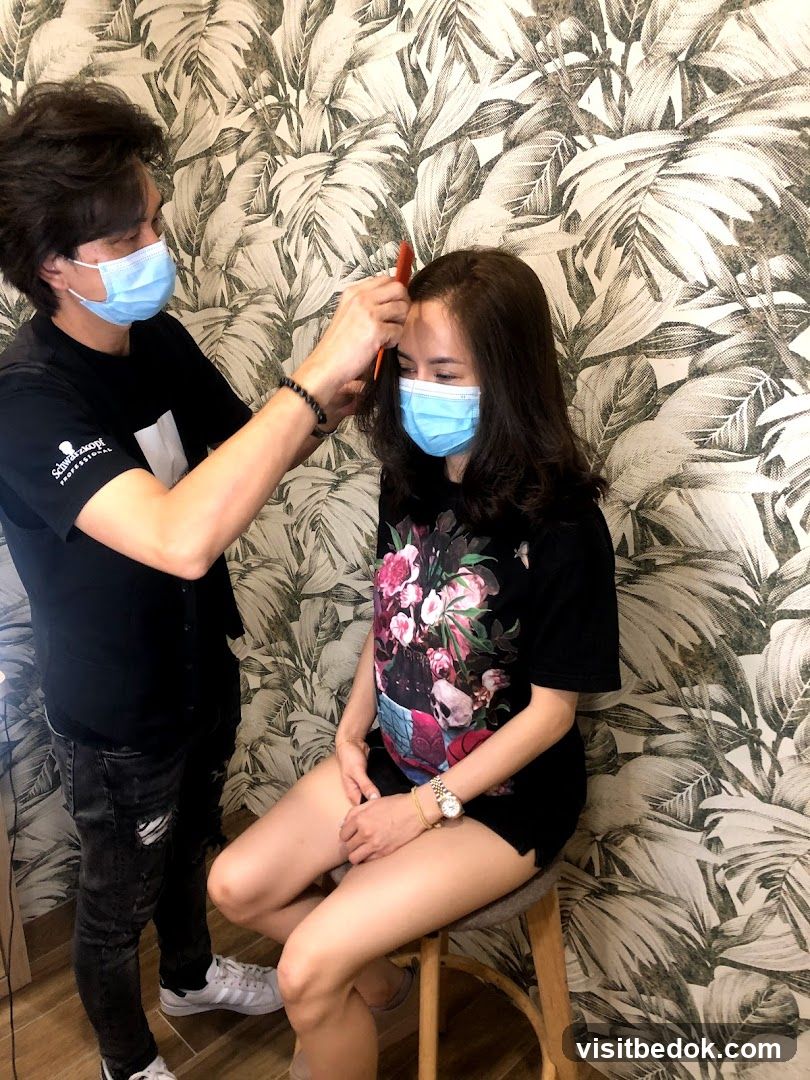Hairdresser styling a client's hair