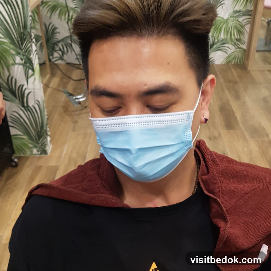 Man wearing a face mask in a salon