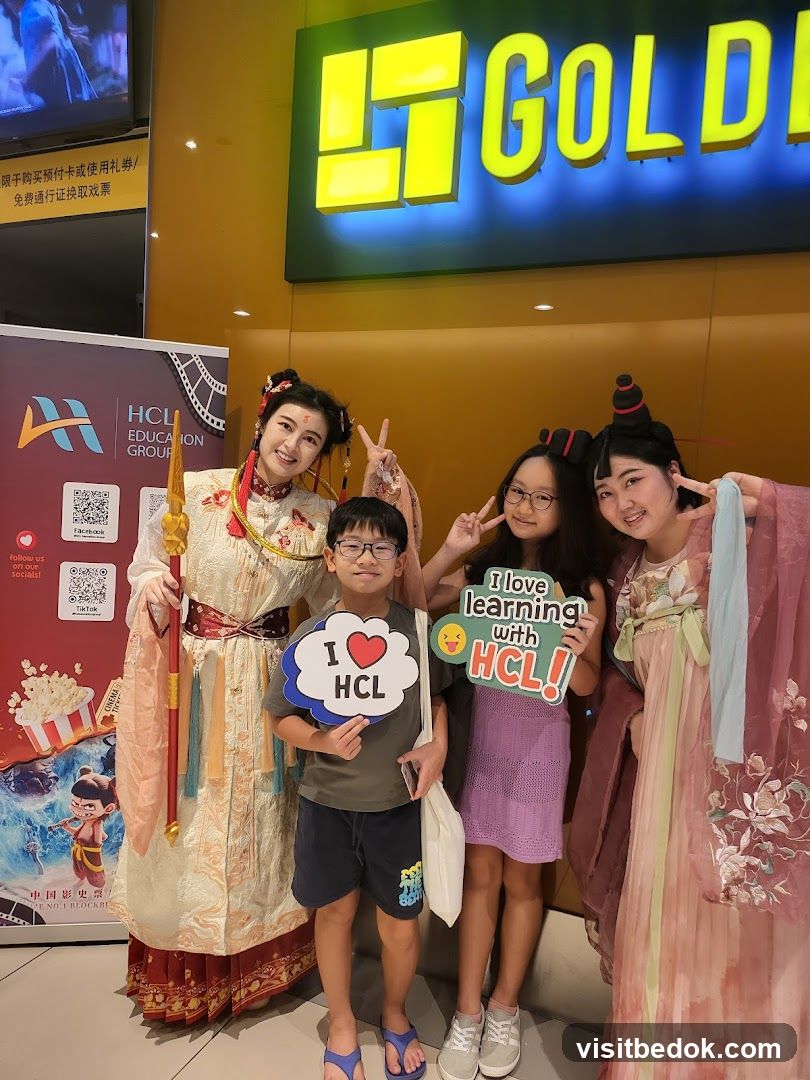 People posing in front of a cinema sign