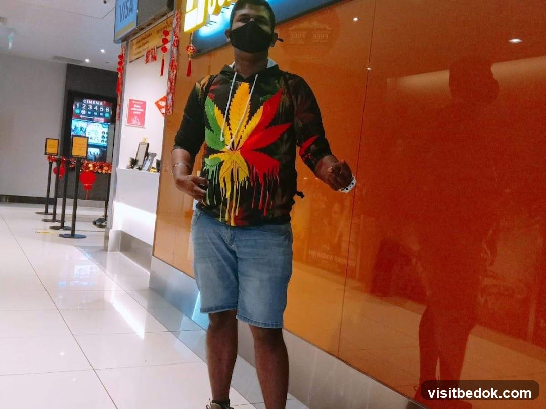 Man in front of a cinema ticket counter