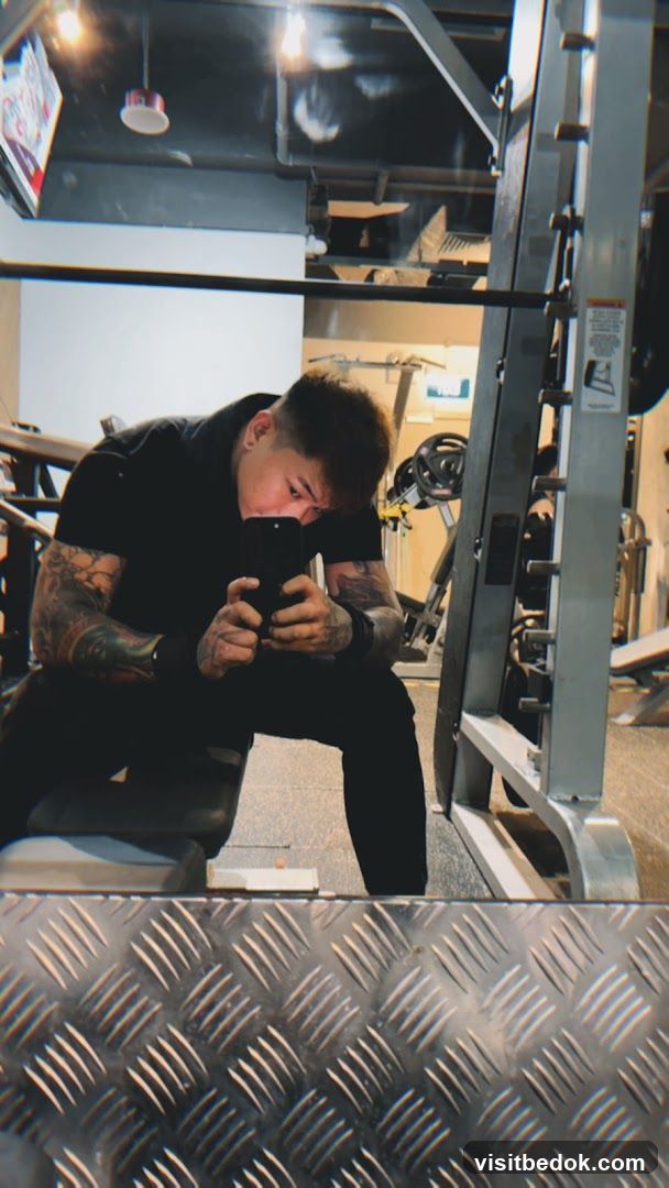Man taking a mirror selfie in a gym
