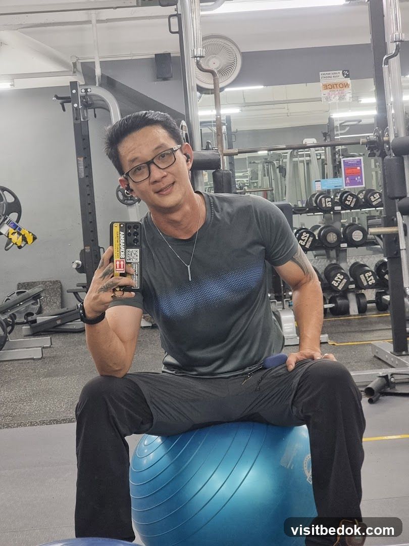 Man sitting on exercise ball in gym