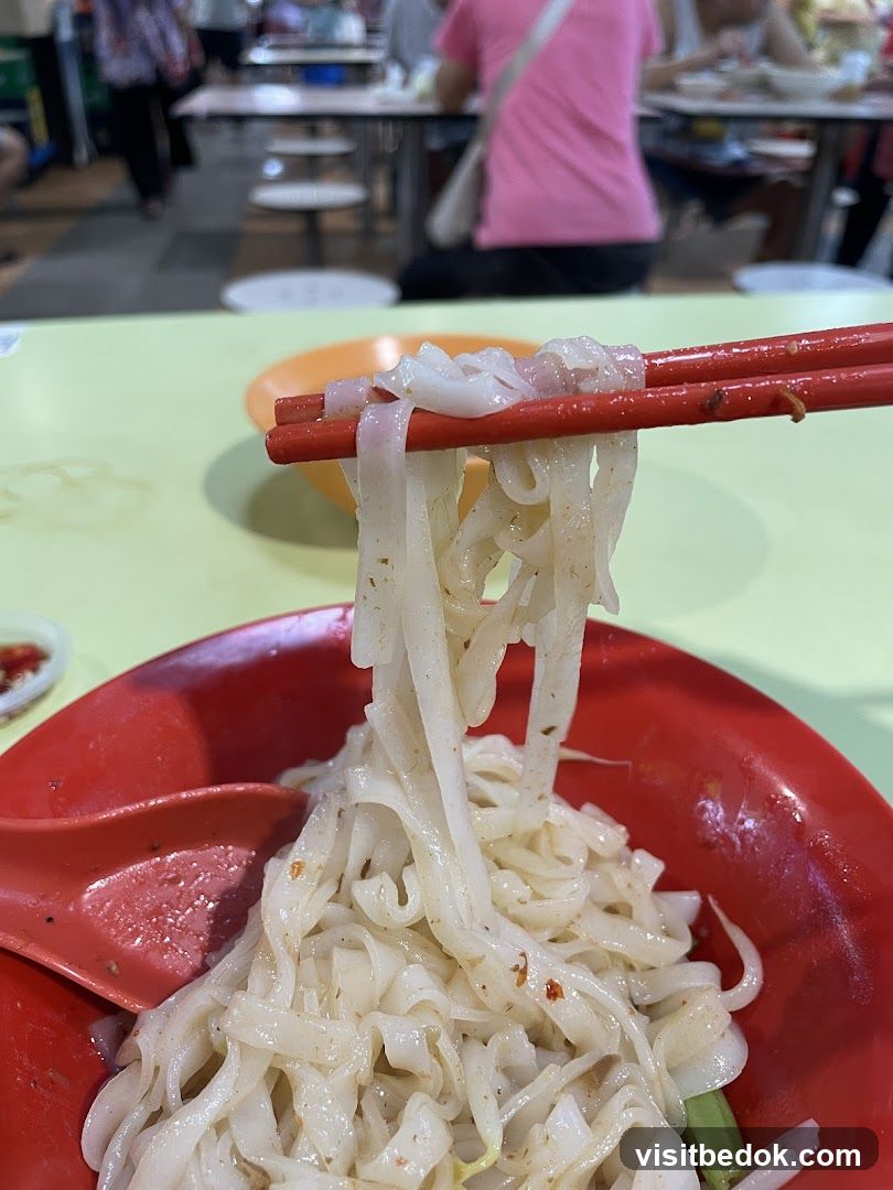 Noodles being lifted with chopsticks
