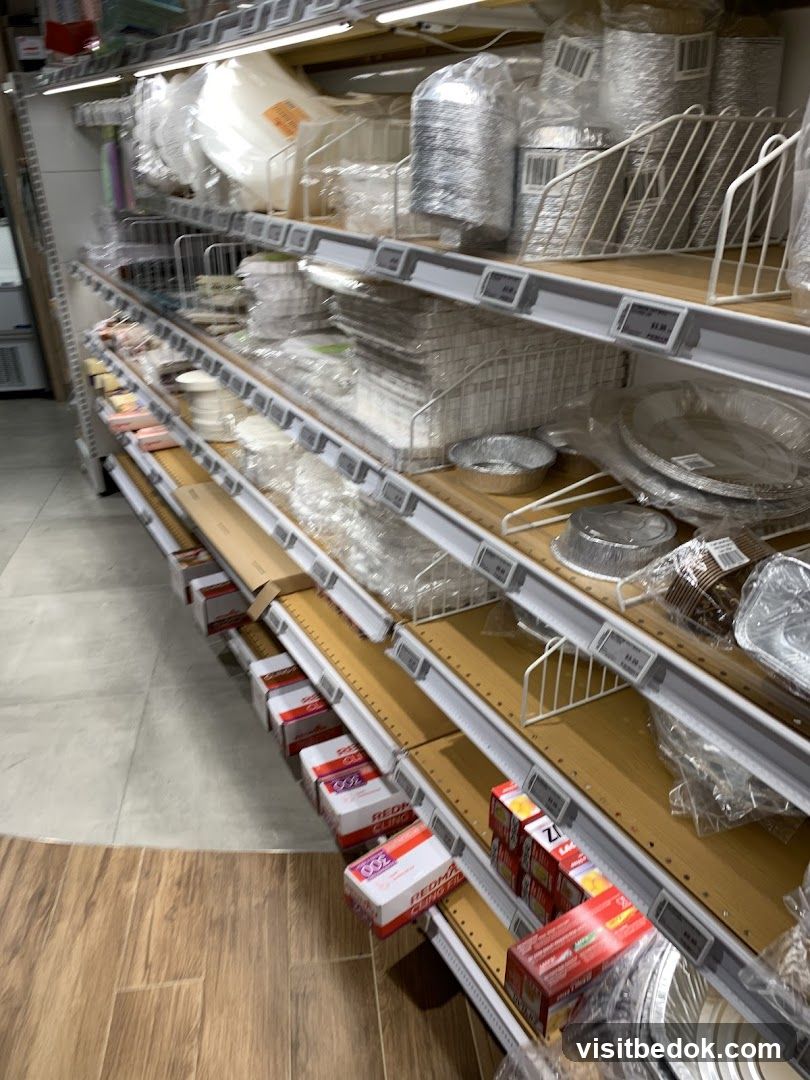 Shelves stocked with disposable food containers and wraps