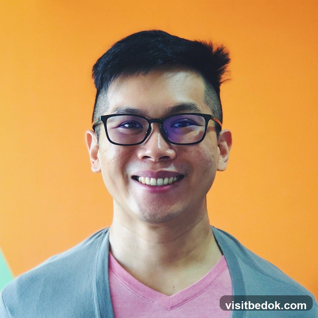 Man wearing glasses and a pink shirt