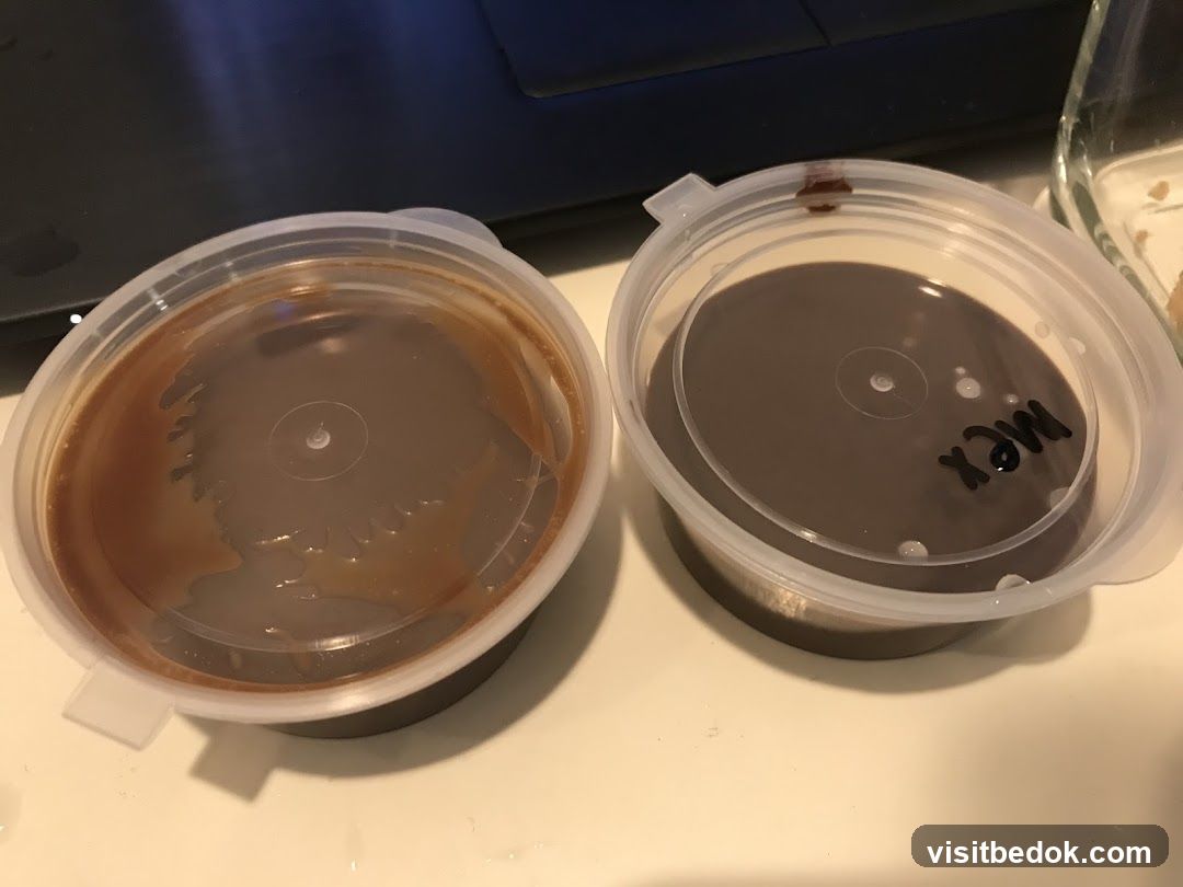 Two containers of chocolate pudding