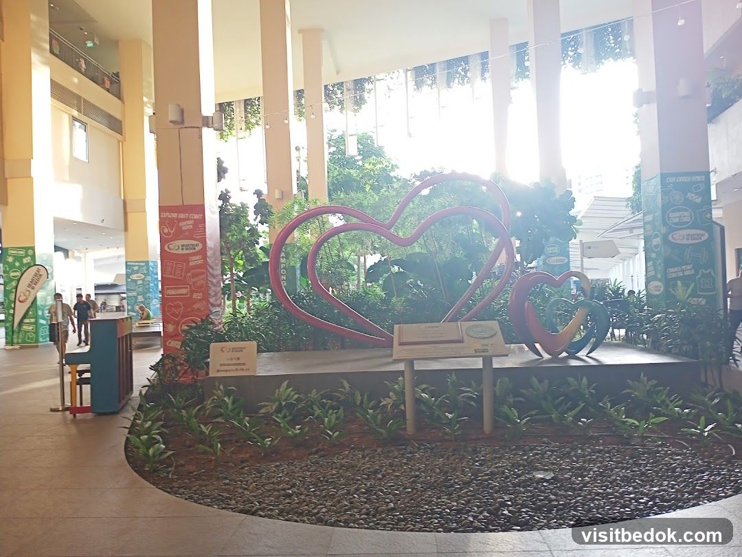 Heart sculptures and greenery in a mall atrium