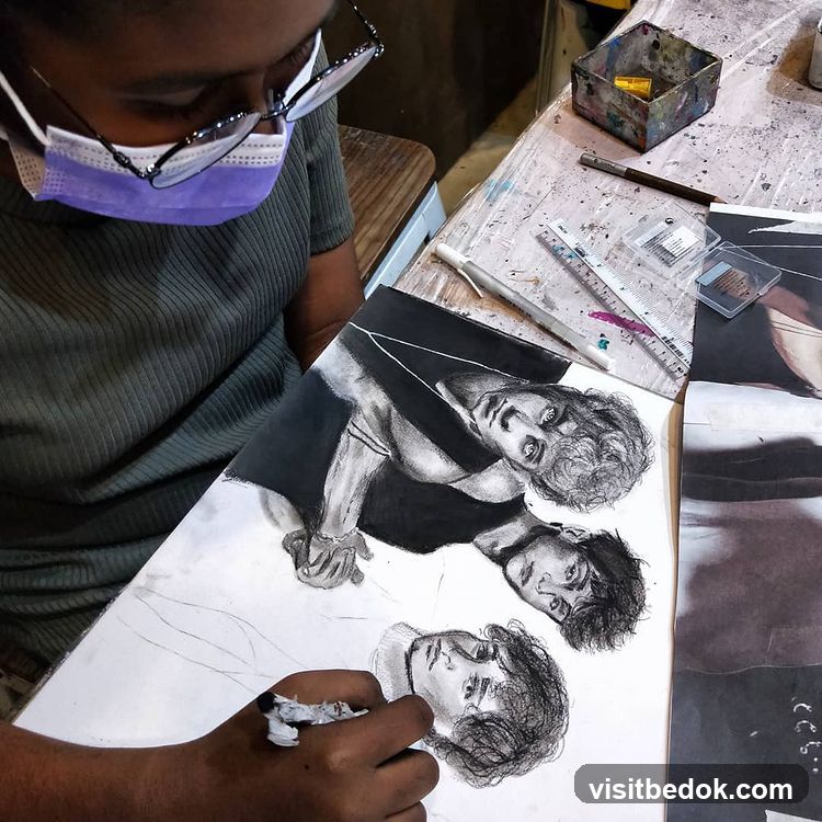 Artist working on charcoal portraits