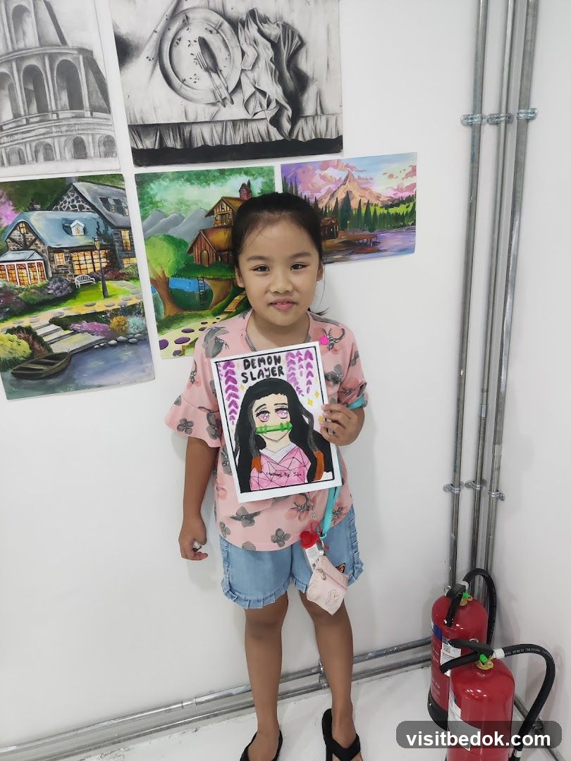 Young girl holding a drawing