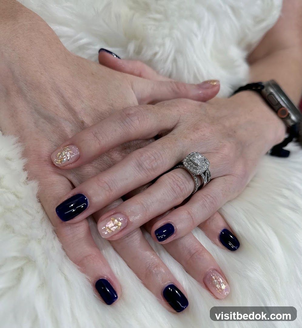 Nails with dark blue and gold accents