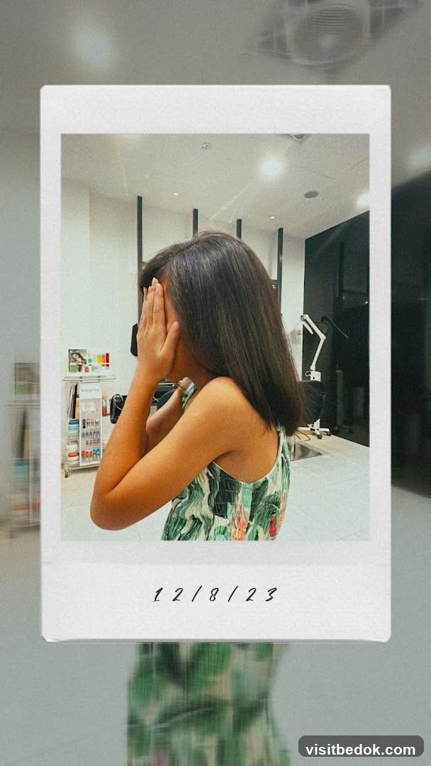 Woman with long dark hair covering her face