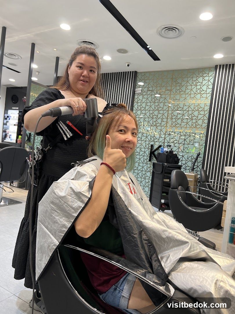 Hairdresser drying client's hair