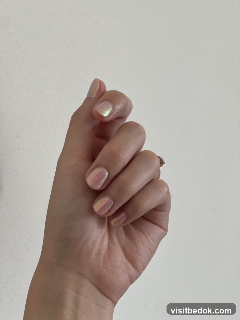 Hand with iridescent nail polish