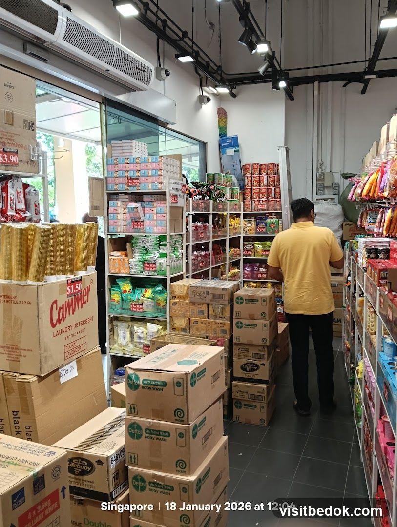 Supermarket aisle with stacked boxes and shelves of products