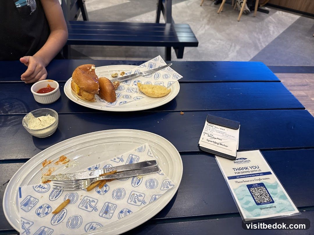 Table with unfinished meal and receipt