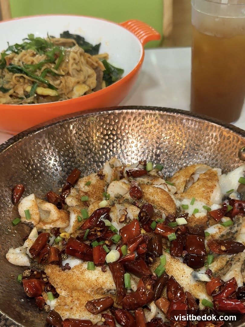 Spicy Fish Dish with Noodles and Drink