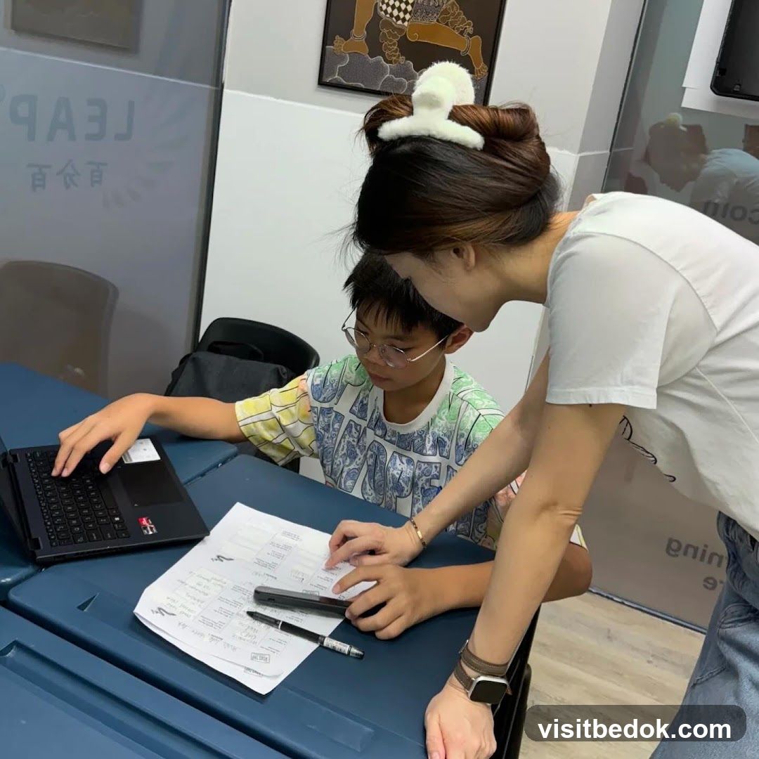 Student and Teacher at Desk
