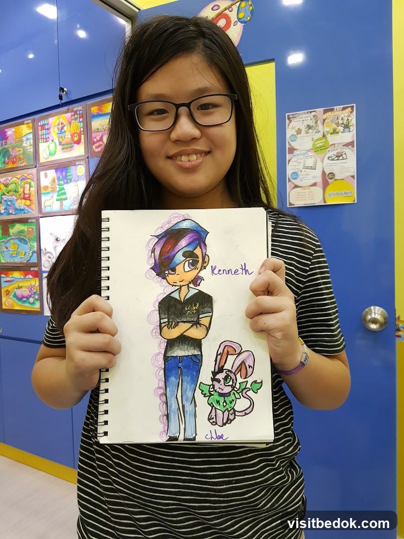 Young artist proudly displays her drawing