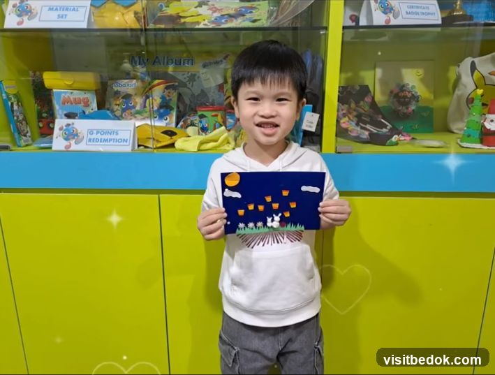 Young boy holding a drawing