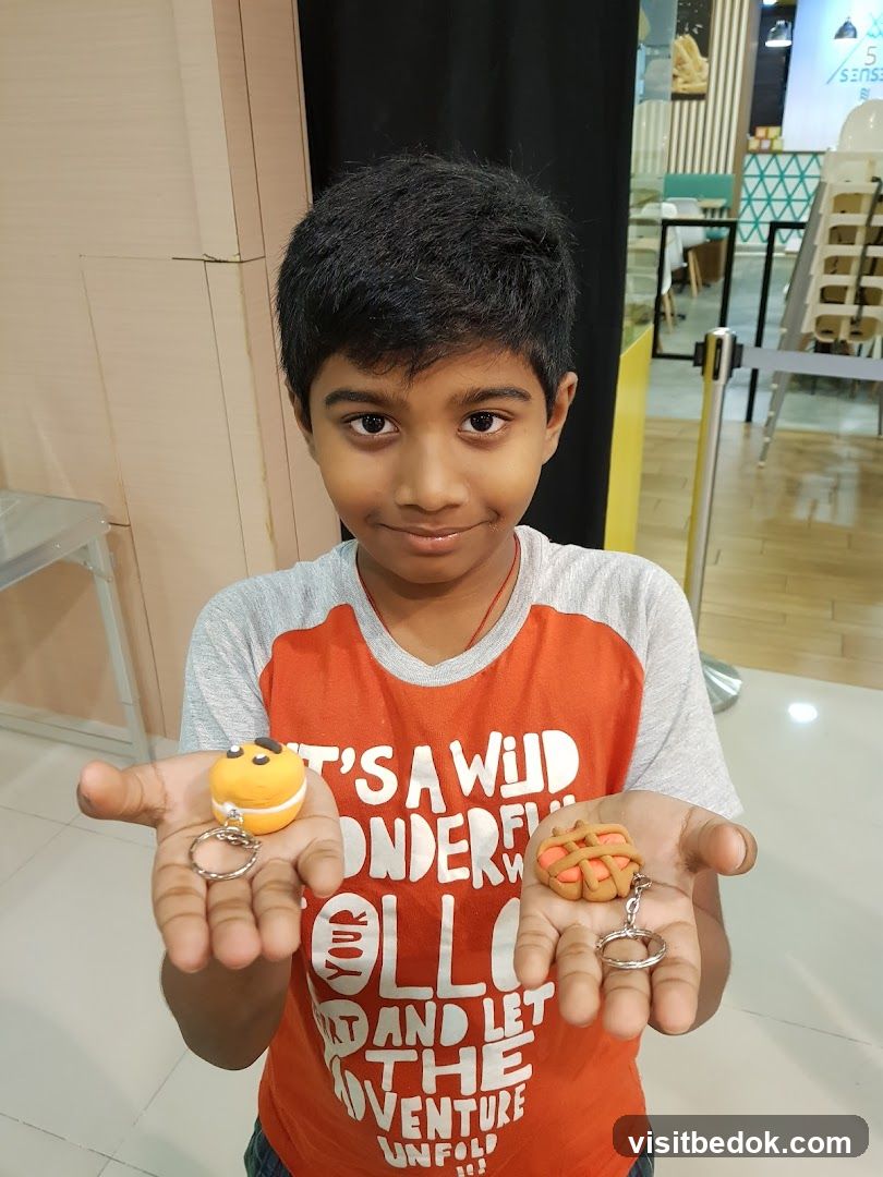 Boy holding clay keychains