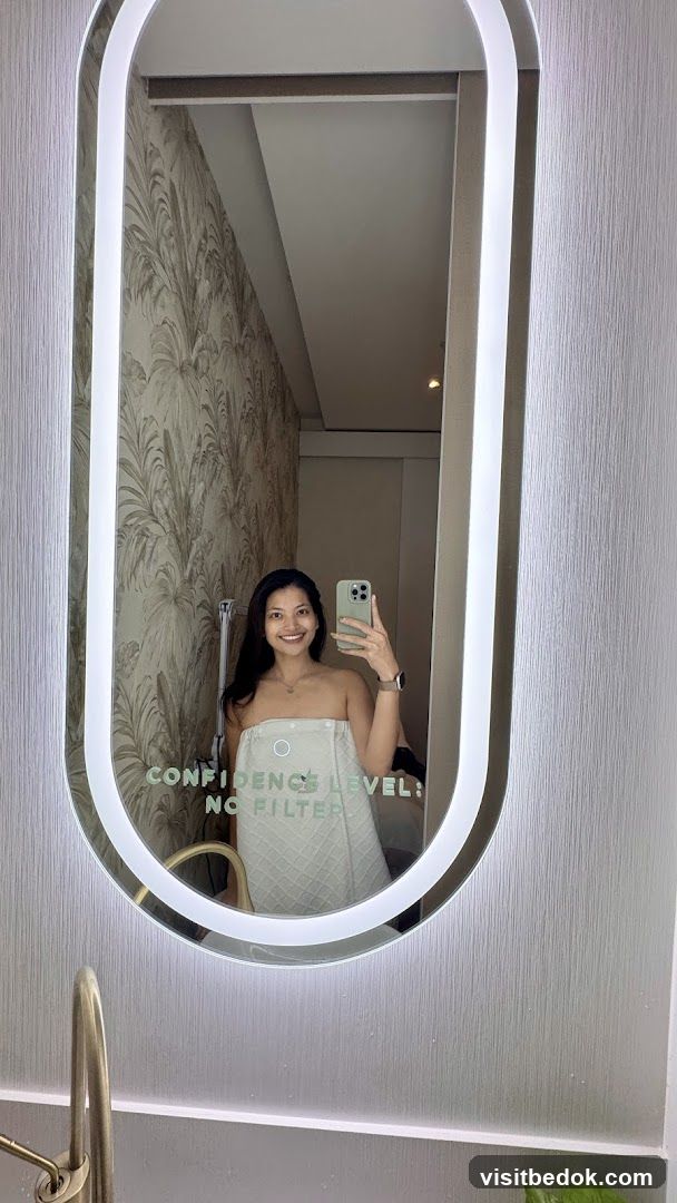 Woman in Towel Taking Mirror Selfie