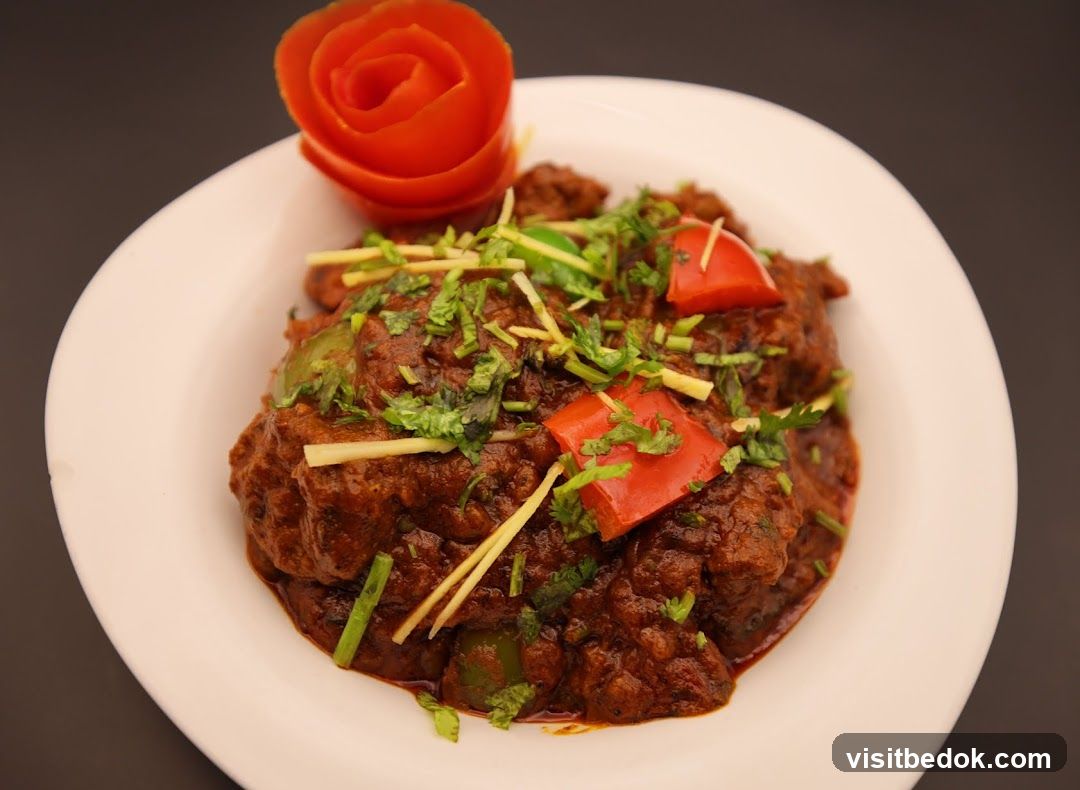 Spicy Meat Dish with Tomato Garnish