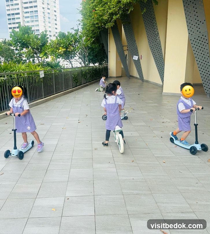 Children riding scooters and balance bikes