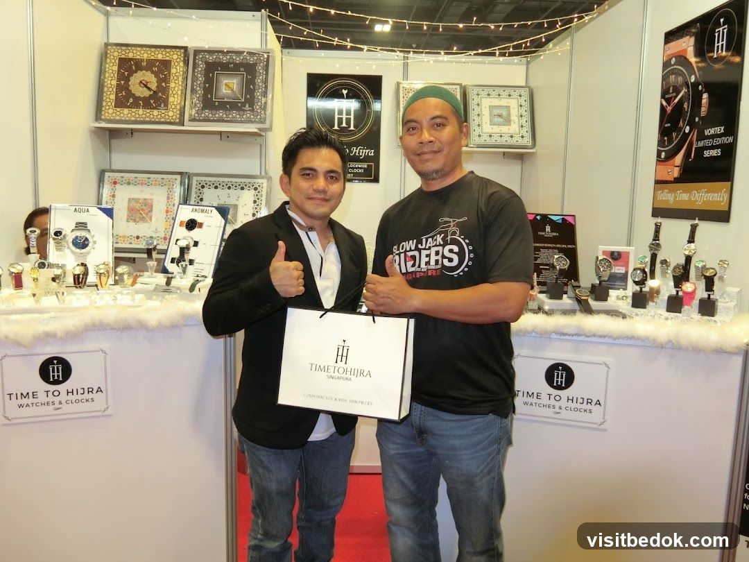 Two men at a watch and clock exhibition booth
