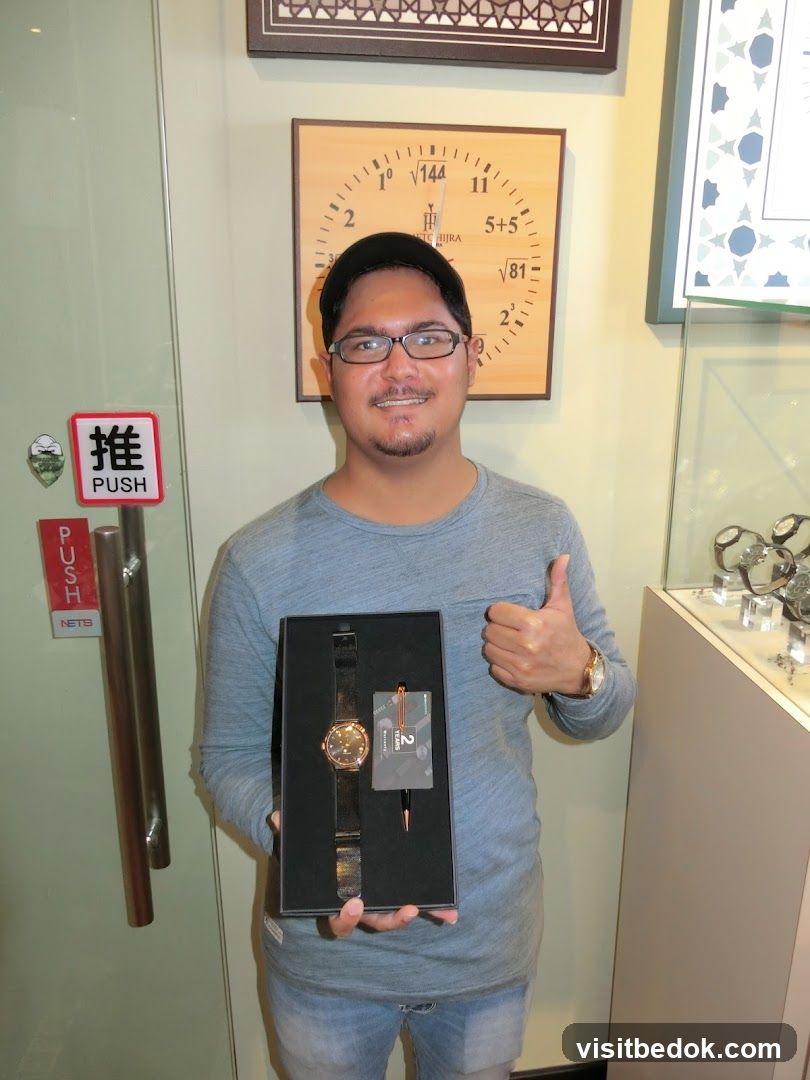 Man holding a watch and pen set