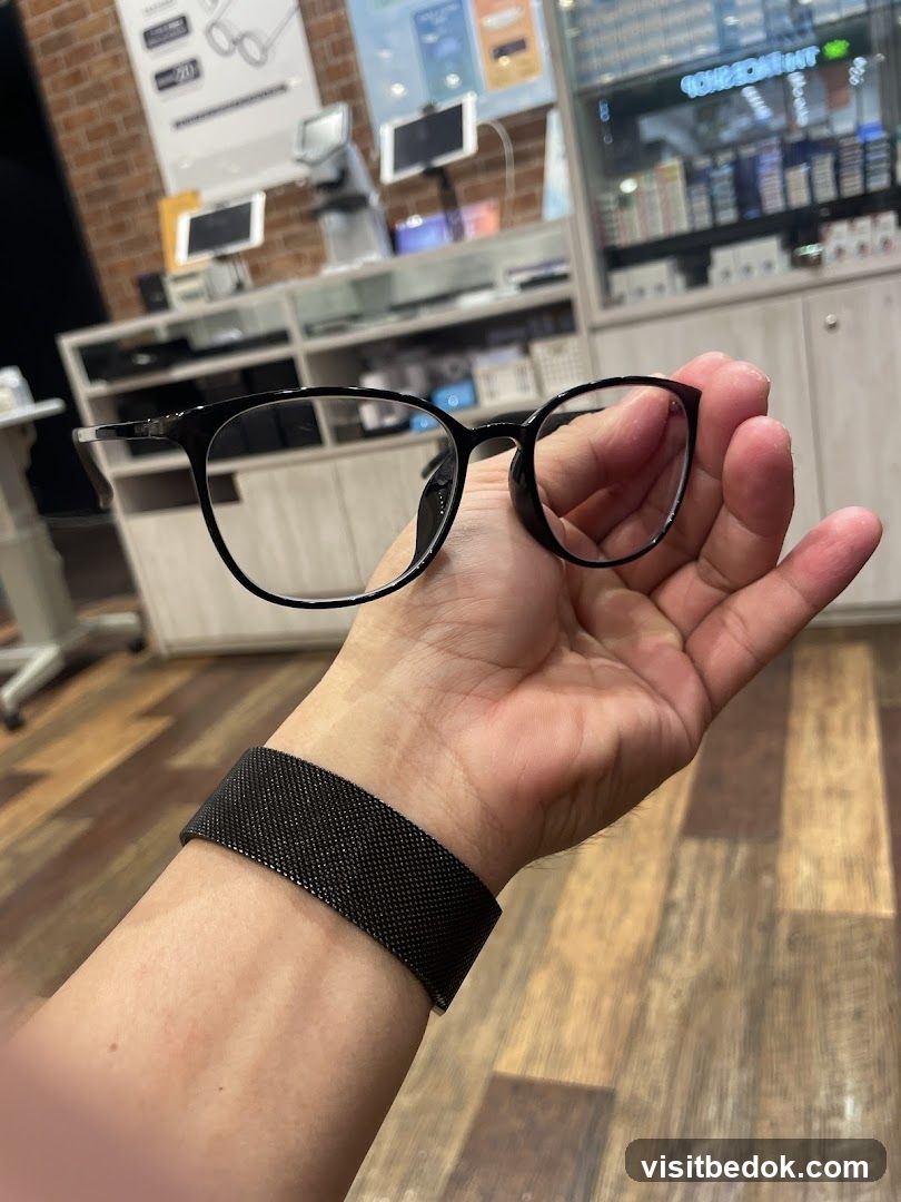 Person holding eyeglasses in an optical shop