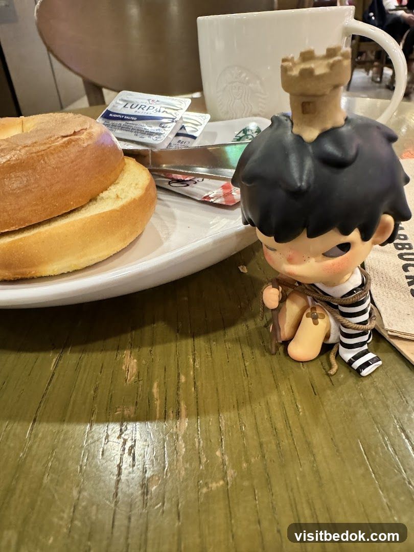 Bagel and coffee with a figurine