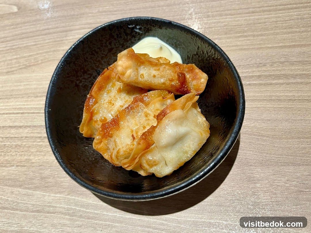 Pan-fried dumplings with dipping sauce