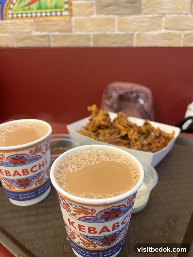 Two cups of tea and fried food