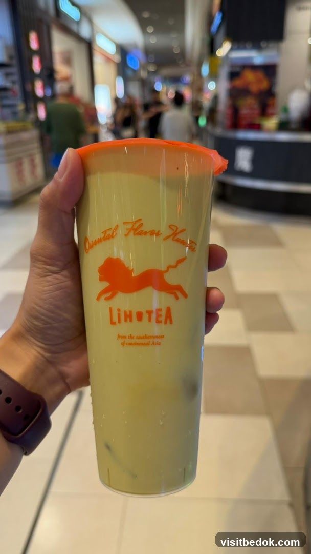 Hand holding a cup of green tea