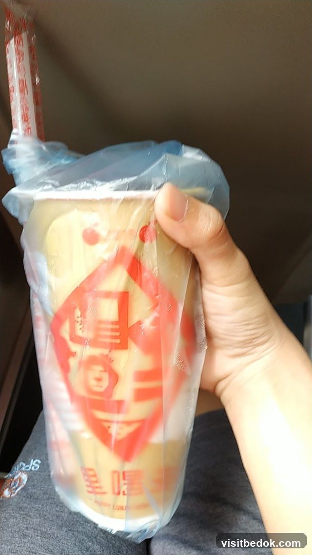 Hand holding a beverage