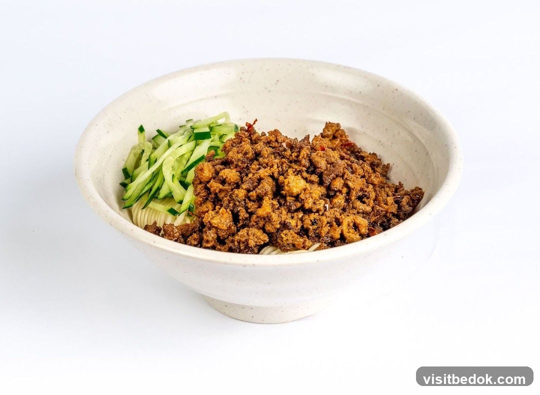 Bowl of Noodles with Minced Meat and Cucumber