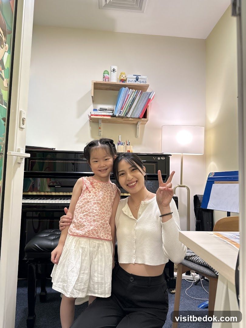 Woman and child posing in a room with a piano