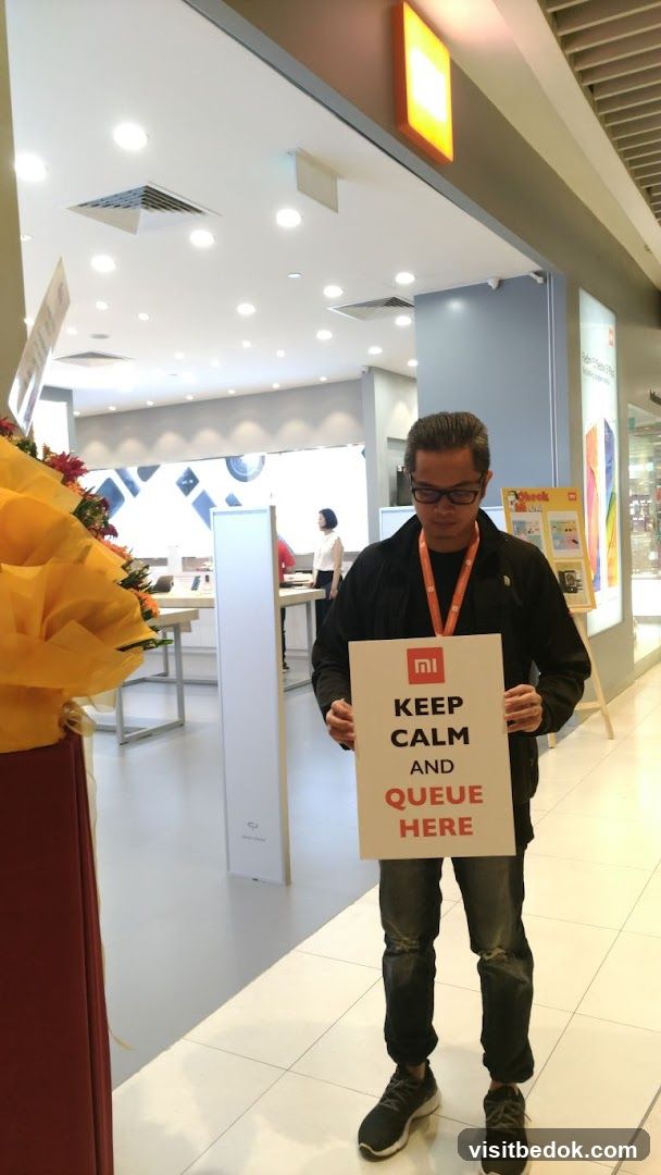 Man holding a sign in a store