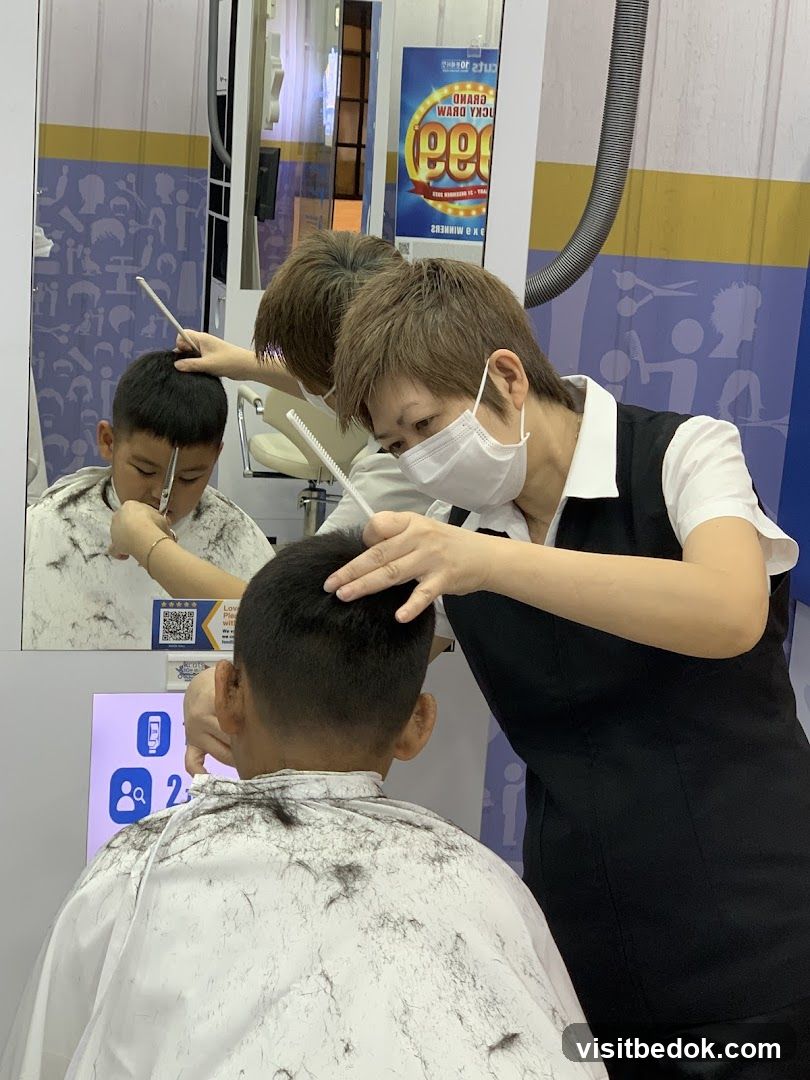 Hairdresser cutting a boy's hair