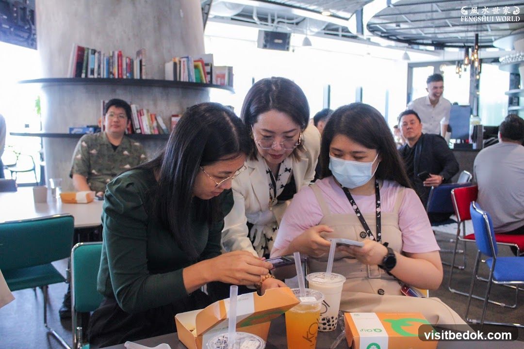 People gathered around a table with drinks and food