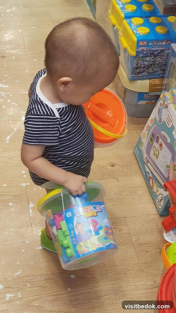 Child holding a bucket of blocks