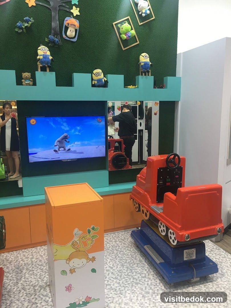 Children's play area with cartoon characters and a ride-on train