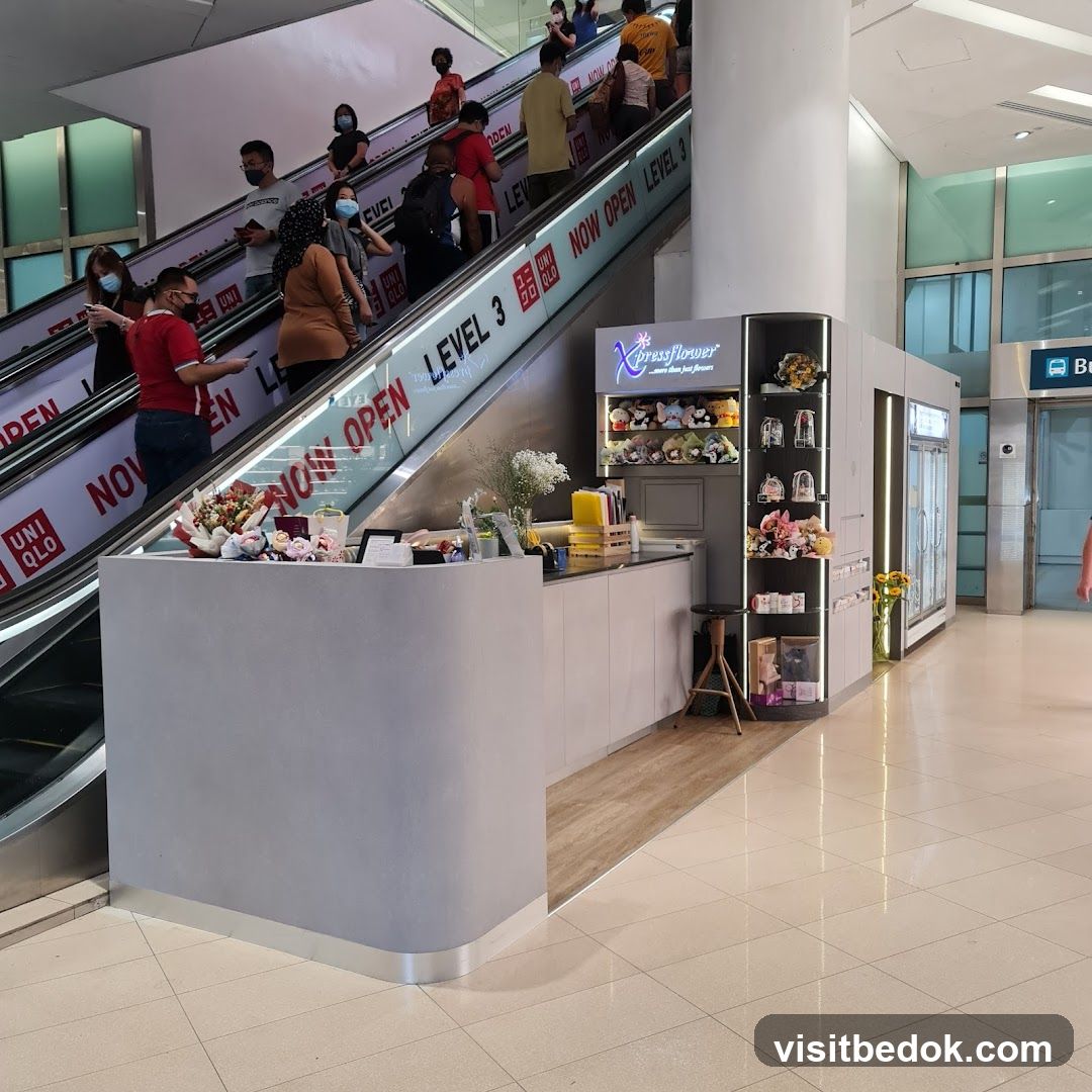 Flower Stand Next to Escalator