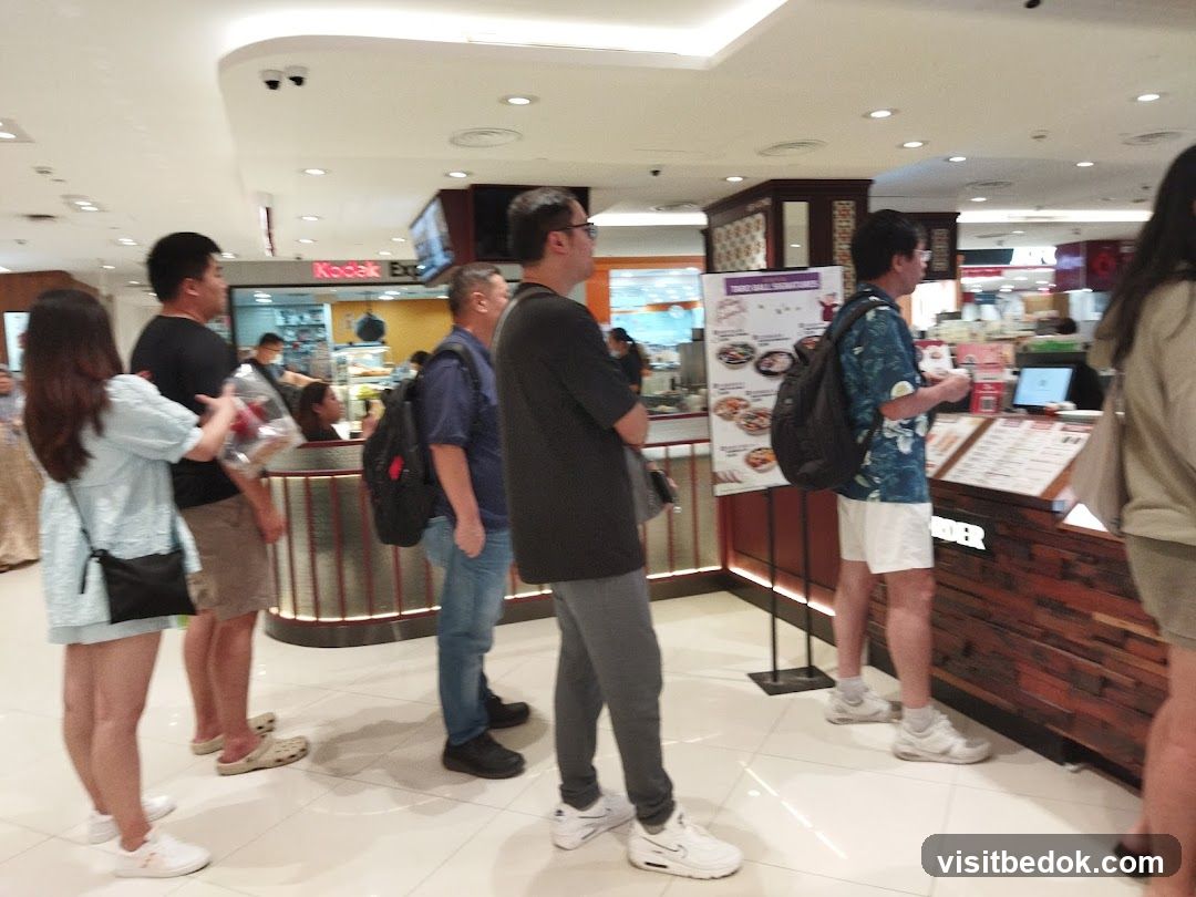 People in a queue at a food establishment